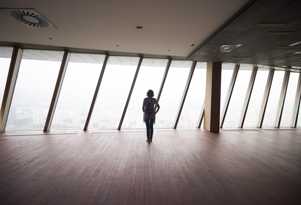 young successful startup business woman in penthouse, modern bright duplex office apartment interior with big windows